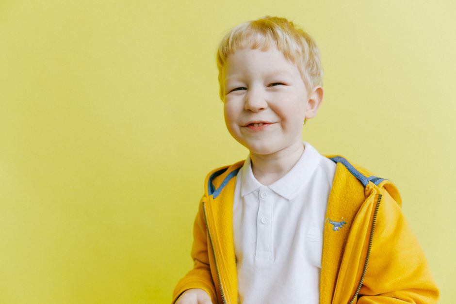 A child squinting to see a distant whiteboard in a classroom setting A child squinting to see a distant whiteboard in a classroom setting