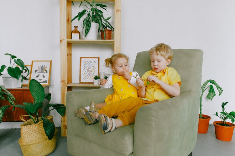 A Photo Of Siblings Eating Grapes