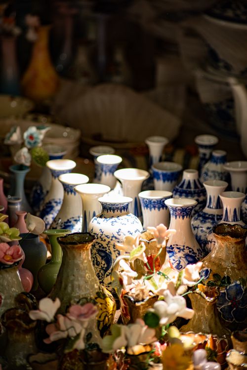 Free A collection of intricately designed ceramic vases with floral patterns, beautifully lit. Stock Photo