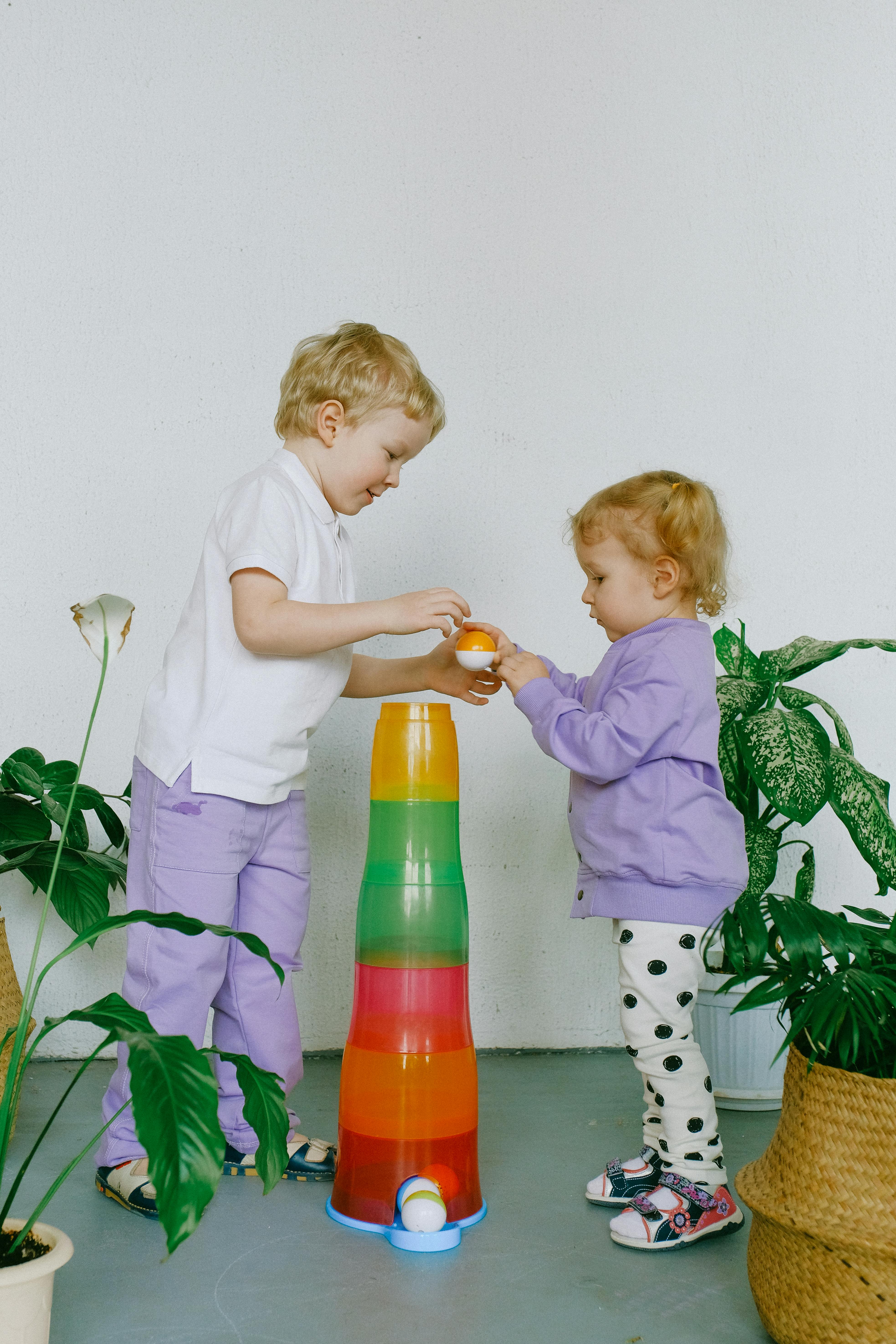 siblings sharing with their toys