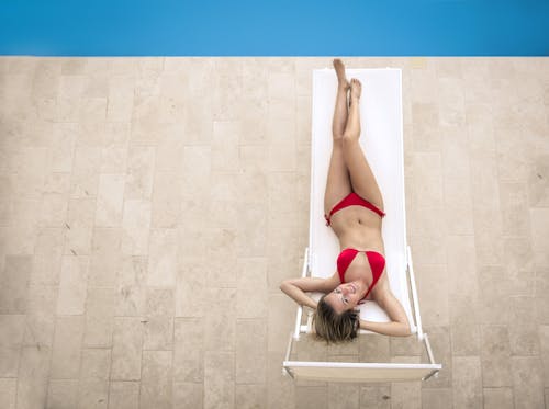 Free Slim woman in bikini lying on deckchair Stock Photo