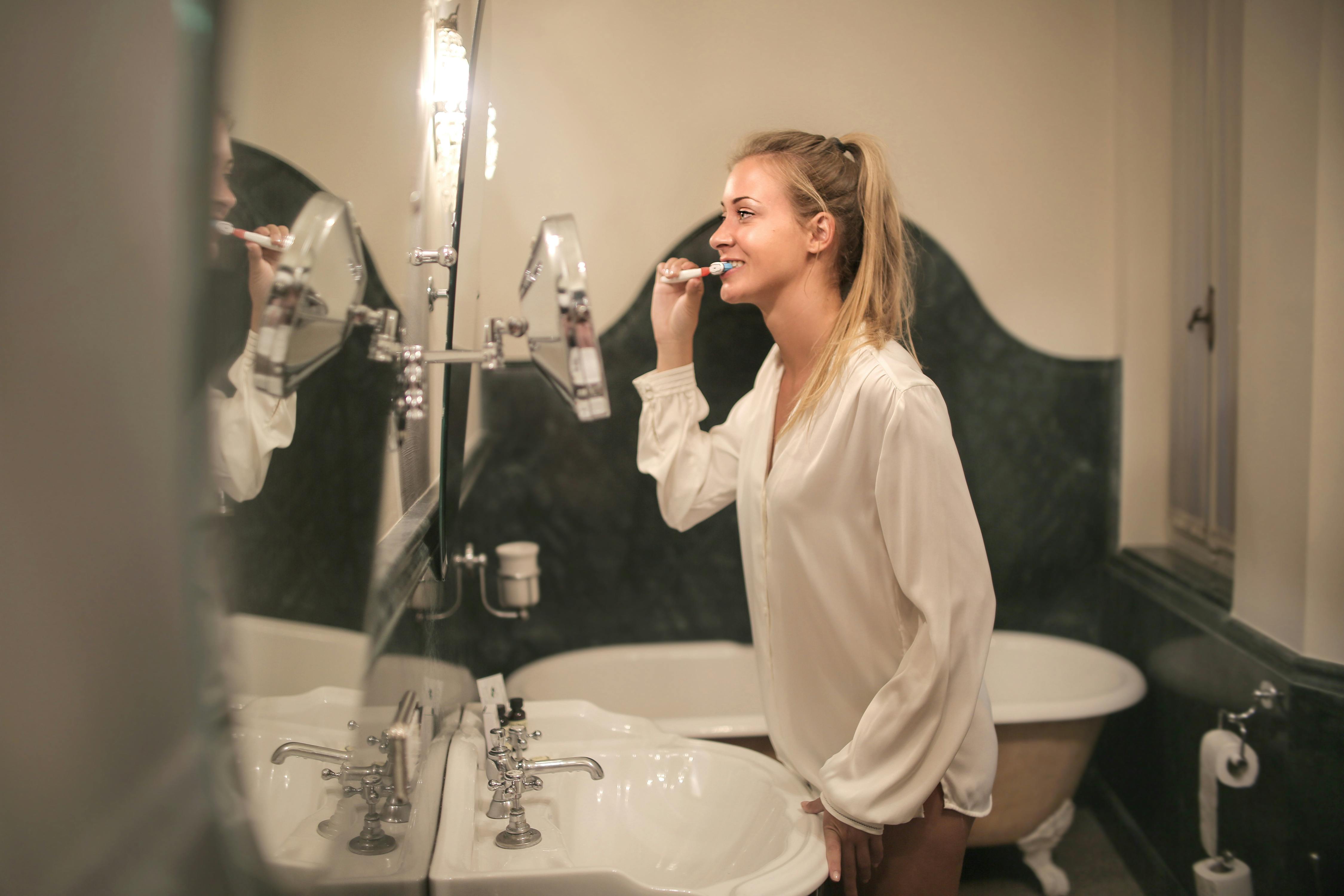 girl brushing her teeth overbrushing