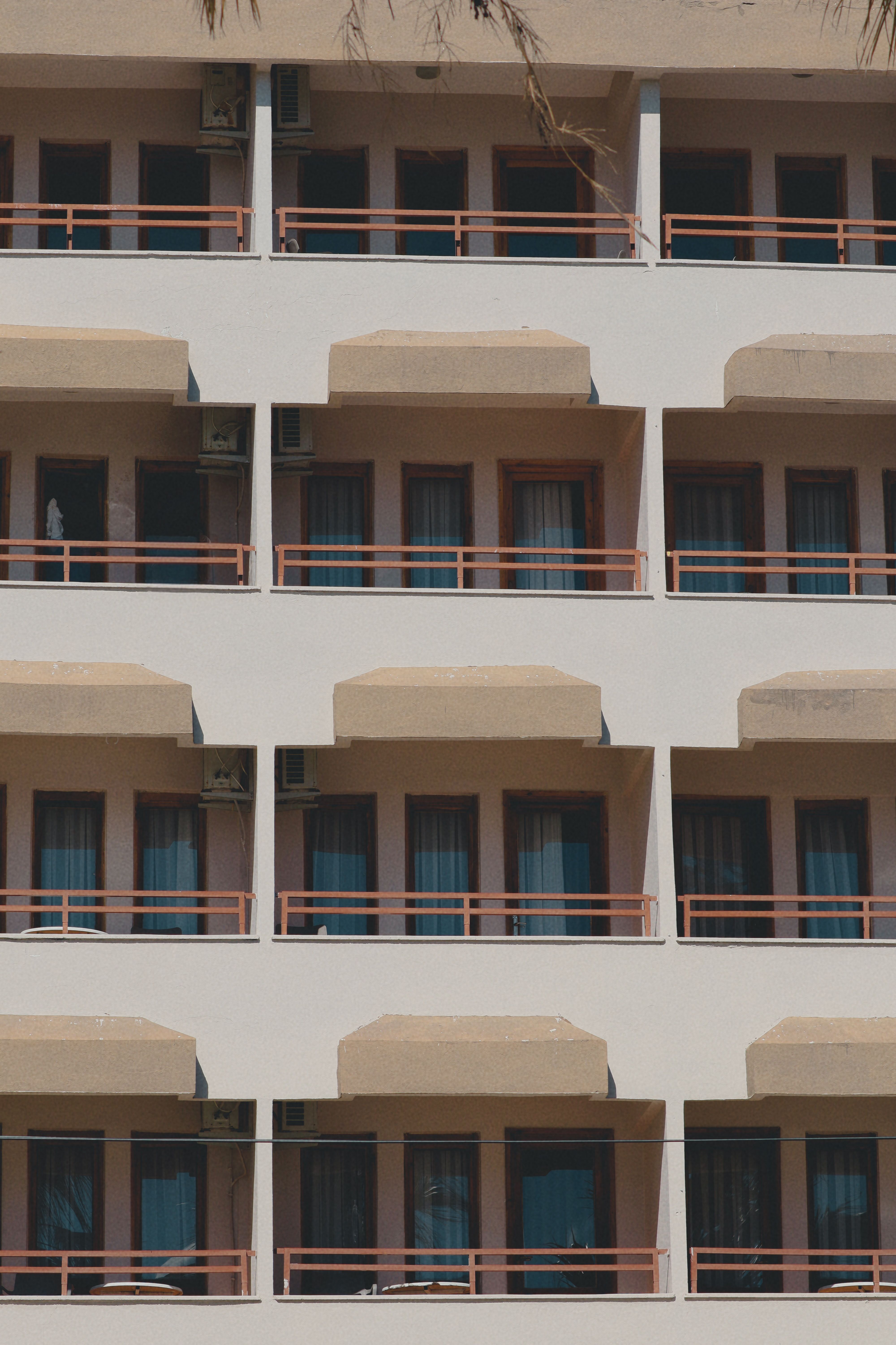 Exterior view of a hotel showing symmetrical design of windows and balconies, perfect for architectural study.