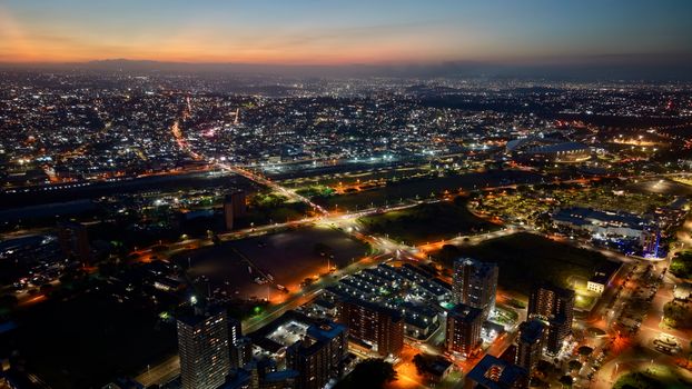 Aerial photograph of Durban's city lights and buildings at twilight, showing urban vibrancy.