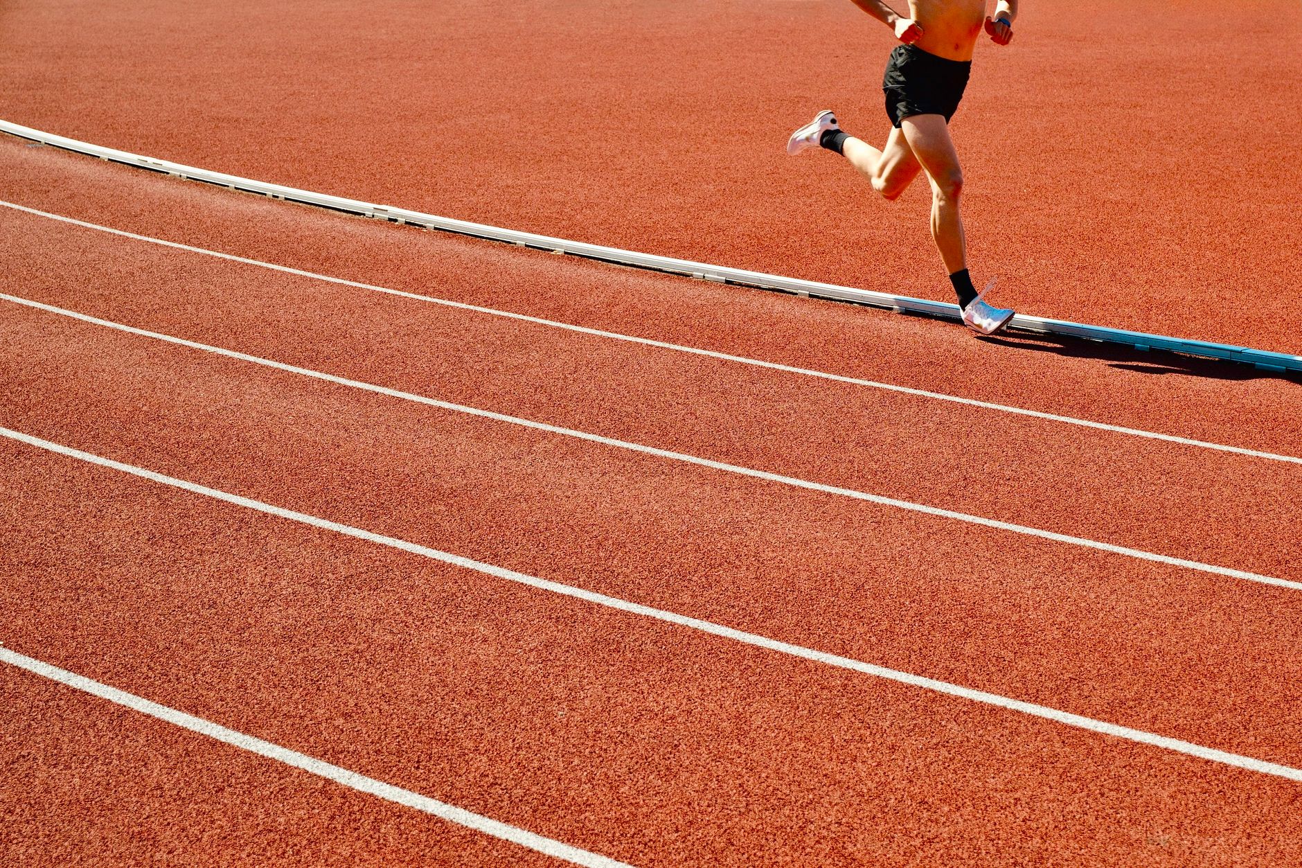 Athlete training on a running track — sports medicine context