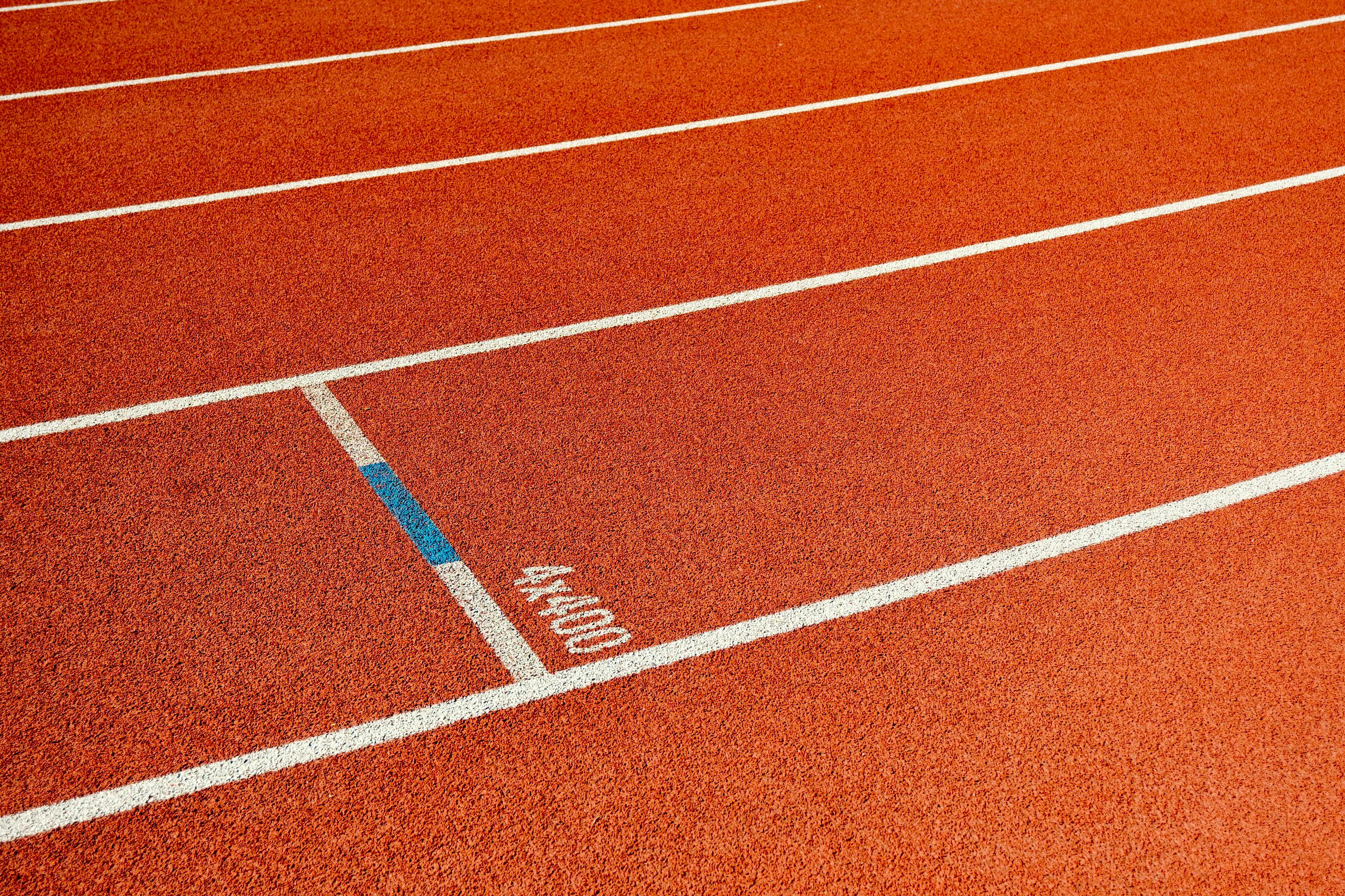 Detailed view of empty athletic track lanes, ideal for sports themes.