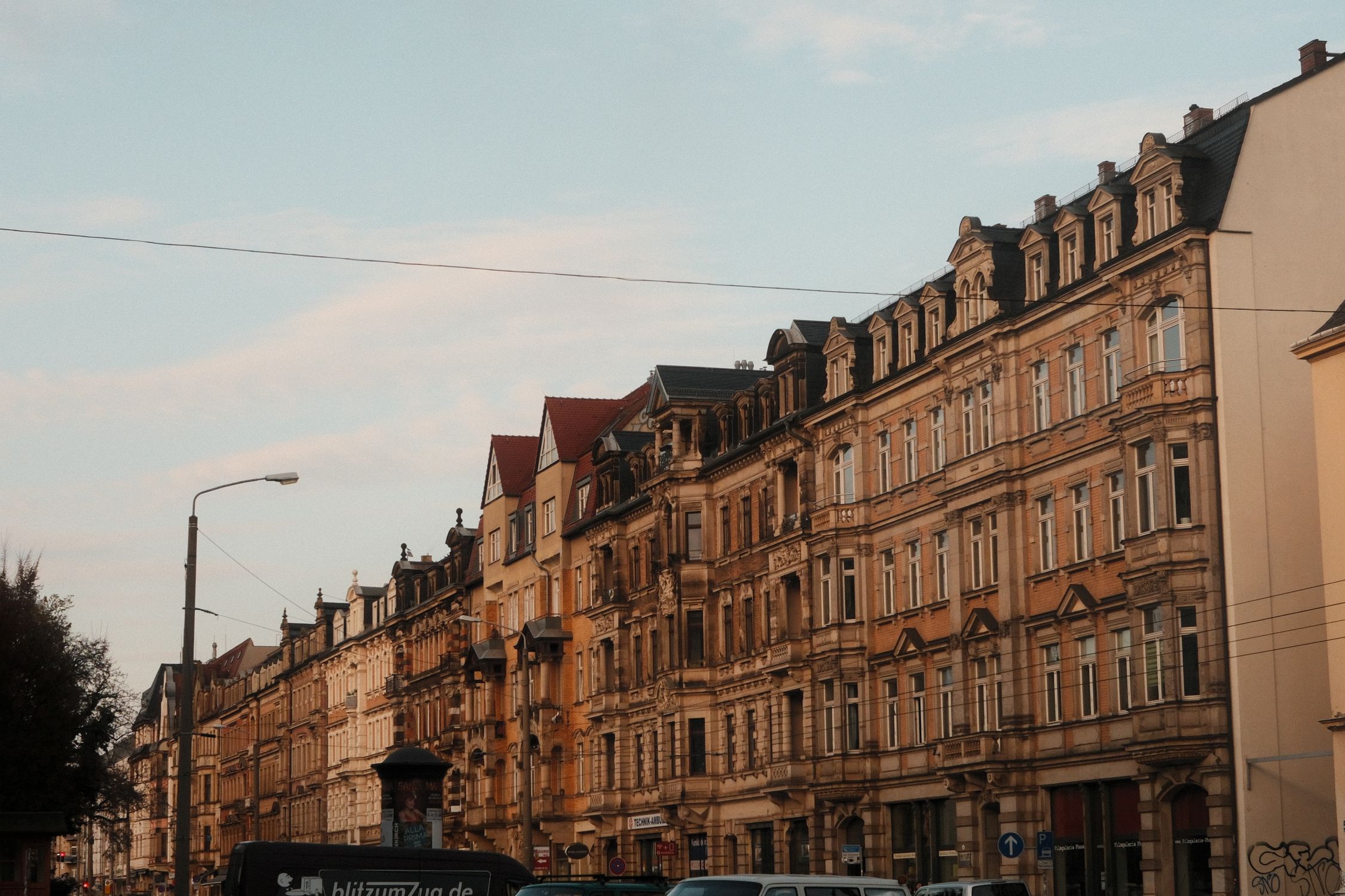 A pastel-colored historic street in a European old town, the kind of well-lit, walkable block that makes solo exploring easier.