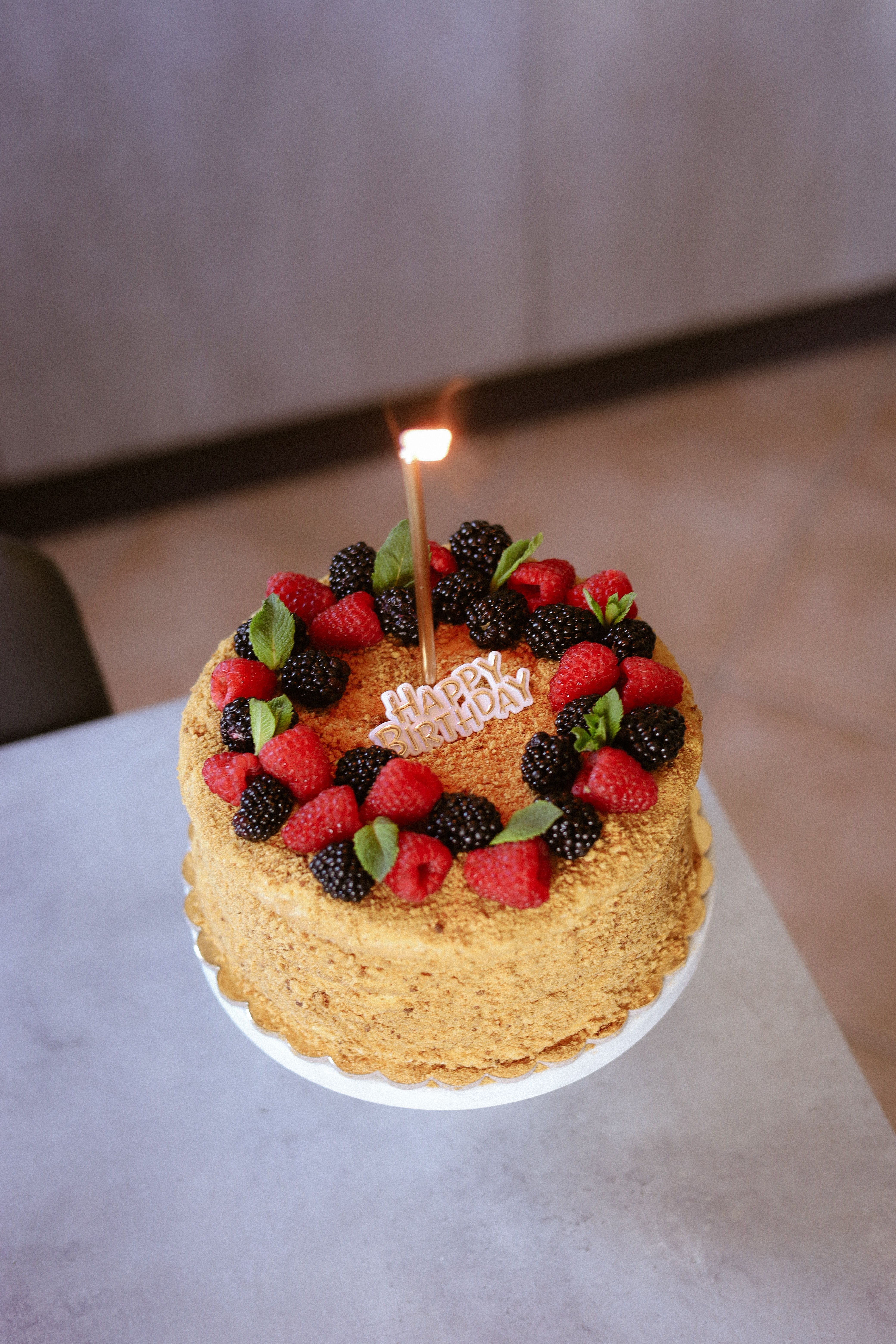 Celebrate with a homemade birthday cake topped with fresh berries and a single candle.