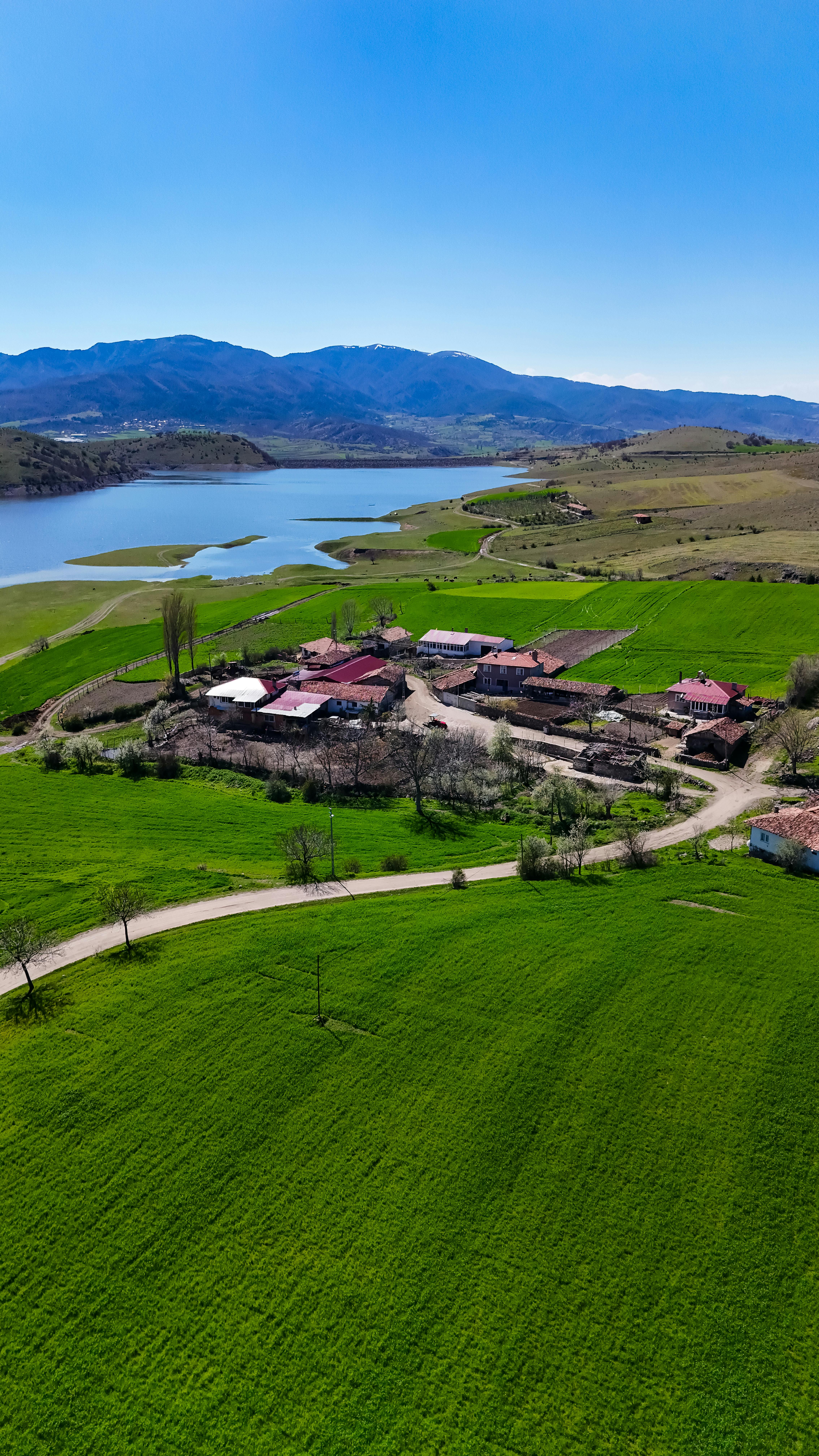Idyllic aerial shot of green countryside and village near Amasya, Türkiye.