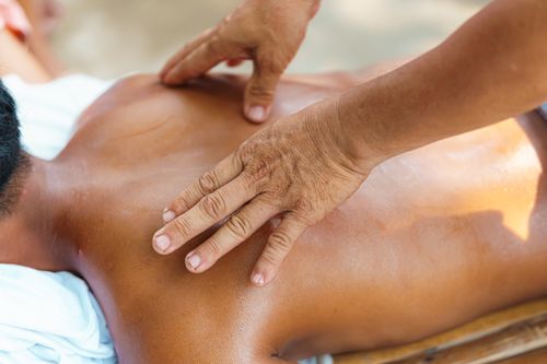 Free Close-up of a relaxing back massage in a tranquil spa environment, capturing the soothing touch of expert hands. Stock Photo