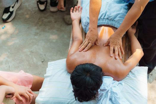 Person receiving a relaxing outdoor back massage, enhancing wellness and relief.