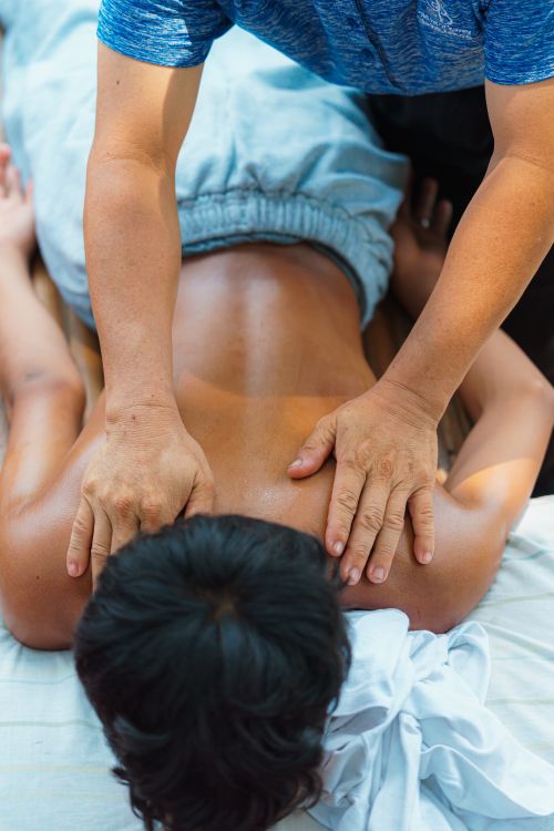 Free A soothing back massage being performed outdoors to relieve tension and stress. Stock Photo
