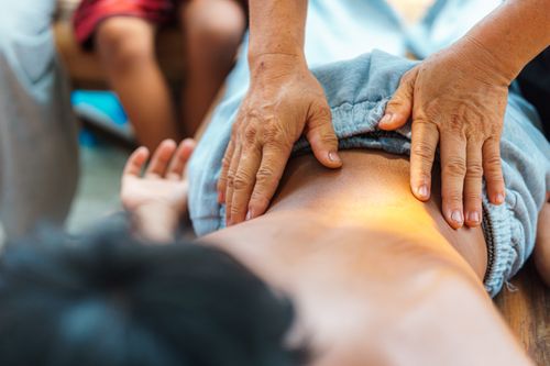 Free A soothing back massage performed by a therapist outdoors, focusing on relaxation and well-being. Stock Photo