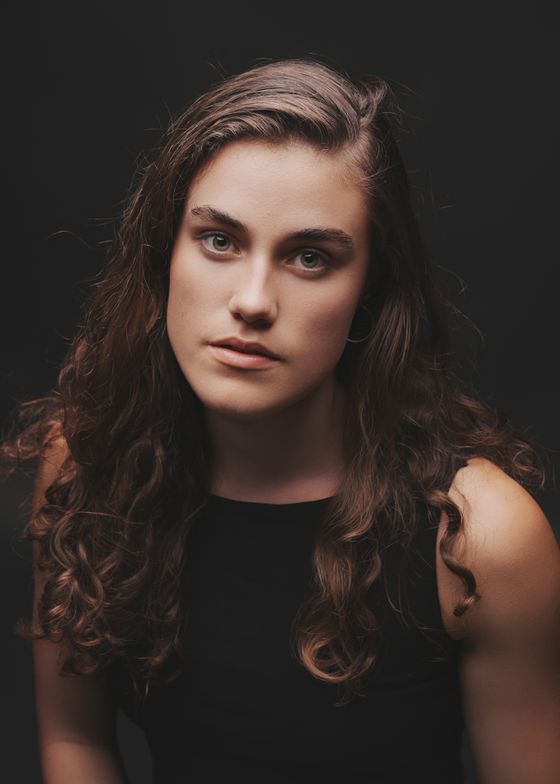 Studio portrait against a dark backdrop — photo by Mario Spencer on Pexels