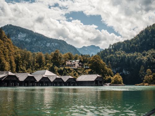 Free Picturesque boathouses on Königssee Lake surrounded by lush mountains in Bavaria, Germany. Stock Photo