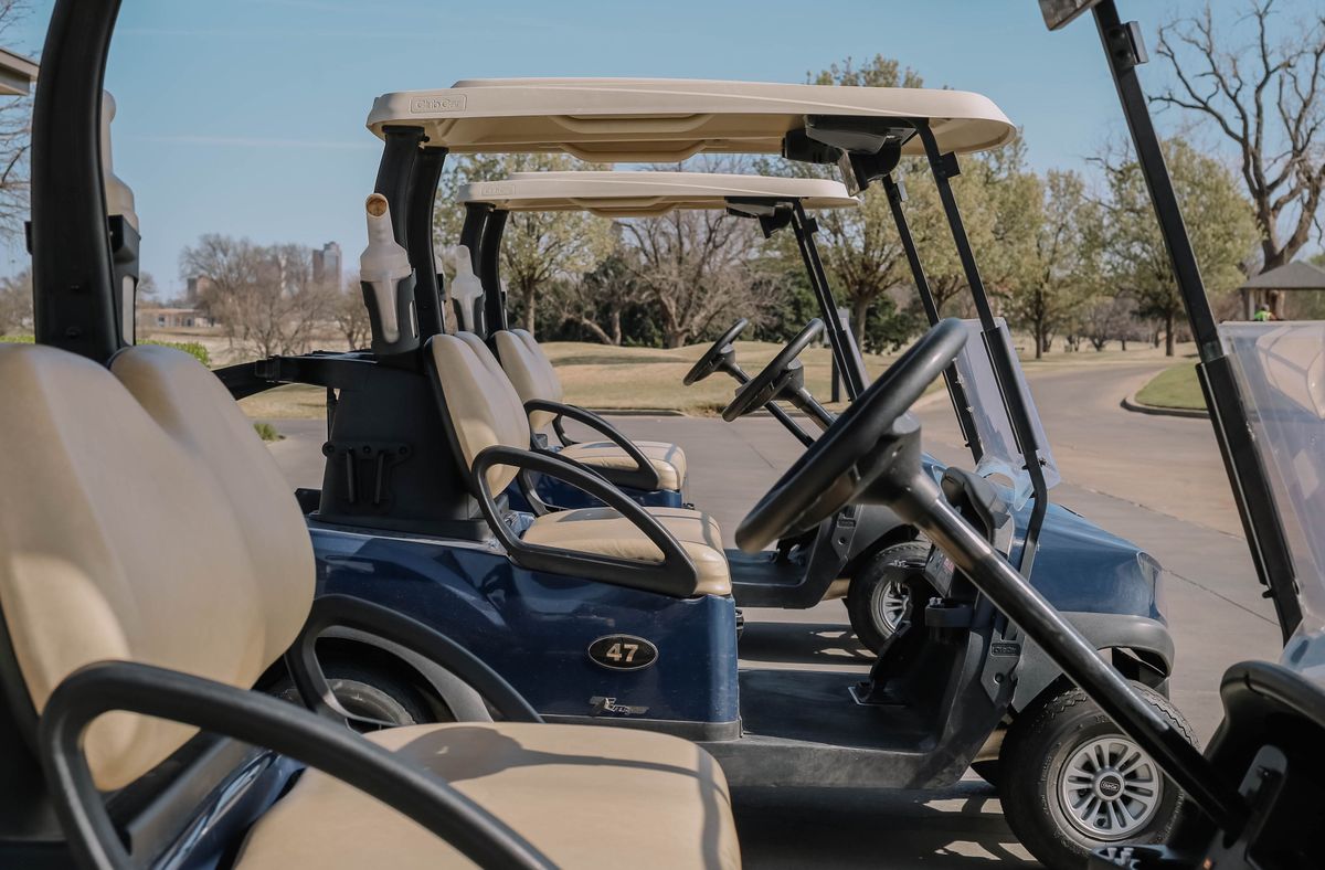 Multiple golf carts displayed together outdoors
