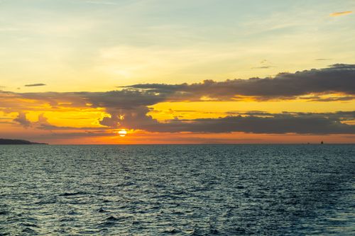 Free A breathtaking ocean sunset with vivid skies and calm sea, capturing the essence of tranquility. Stock Photo