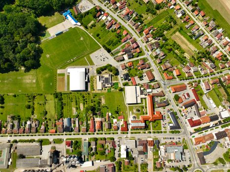 Stunning aerial shot of Garešnica displaying buildings, roads, and green fields on a sunny day.
