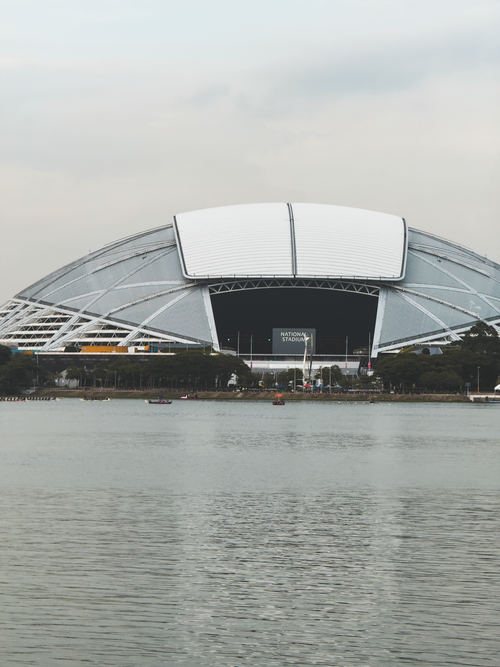 Free Distant view of Singapore's National Stadium from across the calm waterfront. Stock Photo