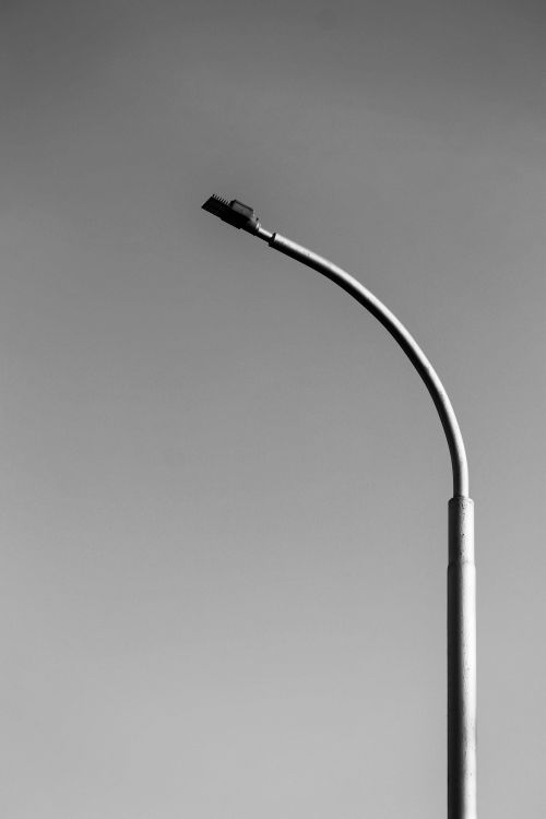 Free Black and white image of a minimalist streetlight against a clear sky. Stock Photo