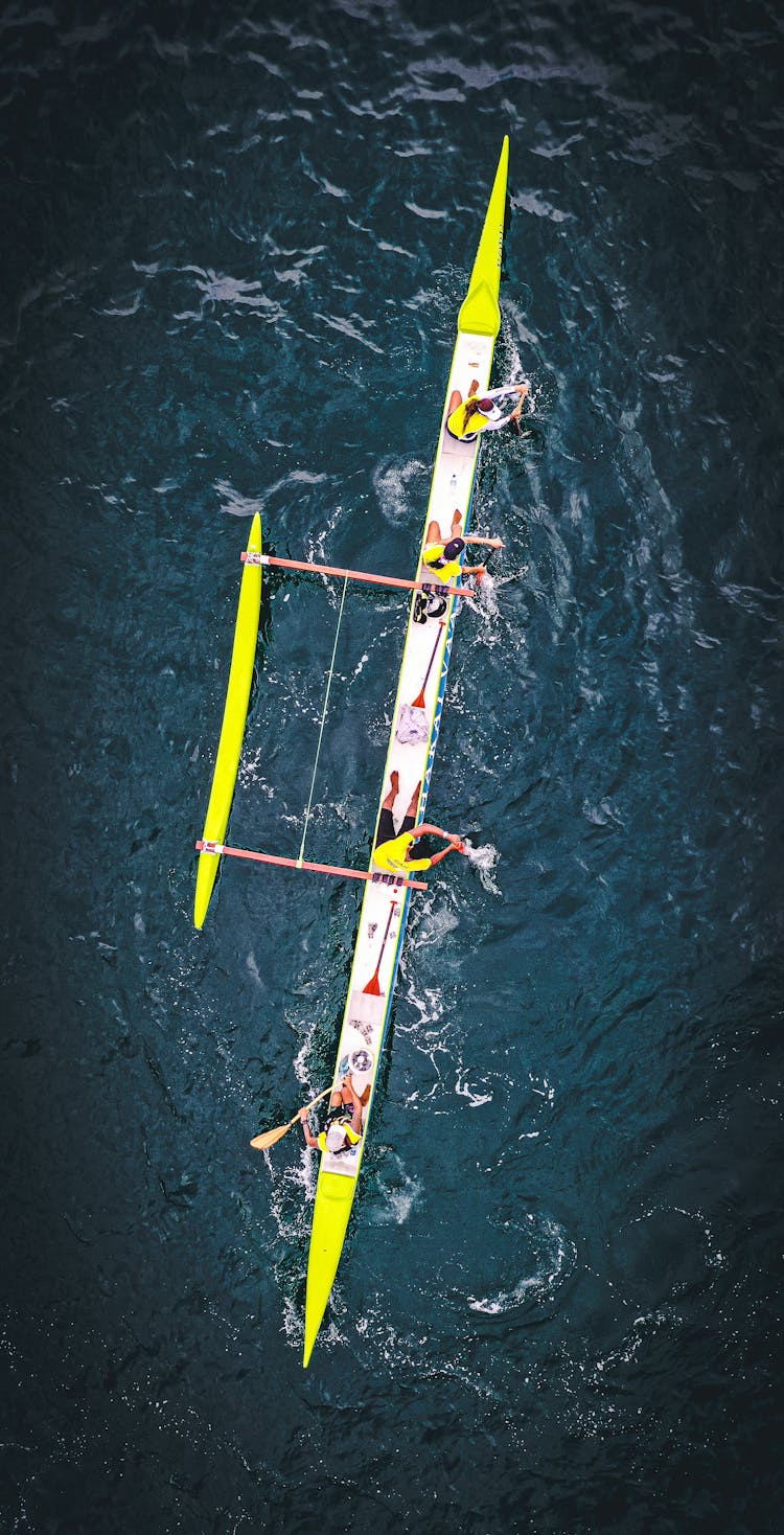 Team In Racing Boat On Water