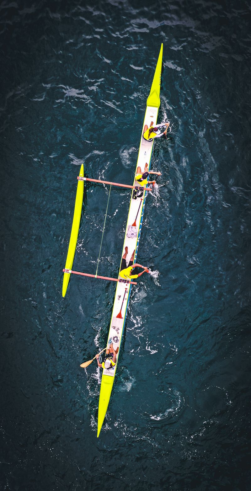 Team rowing in a racing boat on the river, Henley Regatta style
