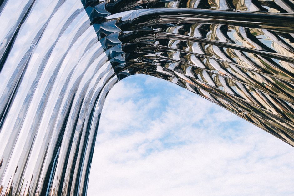 Stunning abstract view of reflective architecture against a clear blue sky in Wrocław, Poland.