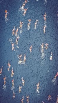 Aerial view of swimmers during competition in sea