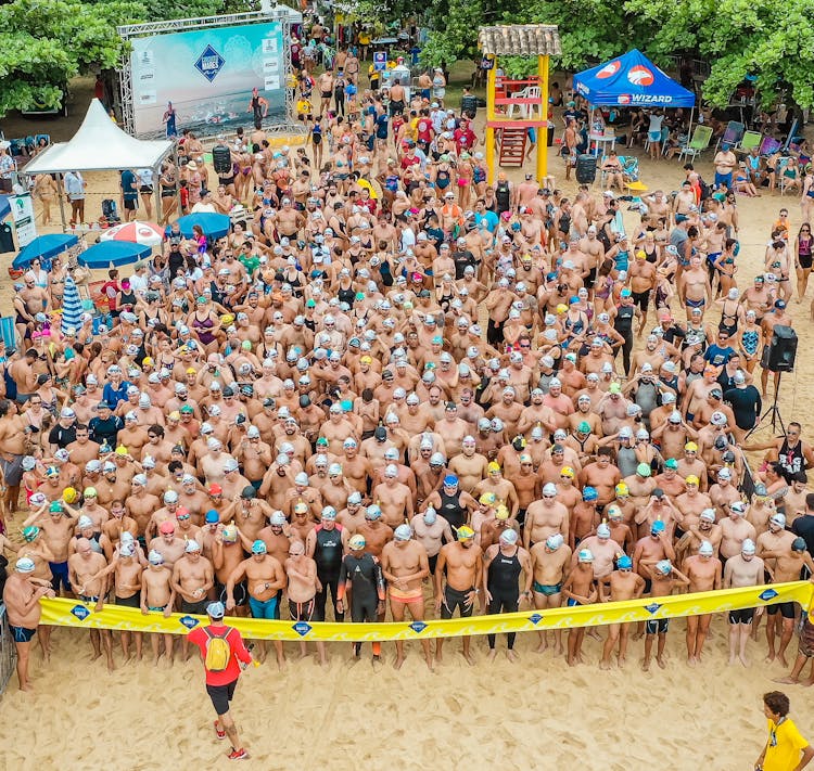 Crowded Beach With Swimmers Participating In Race