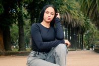 Young woman posing confidently outdoors in lush Montevideo park setting.