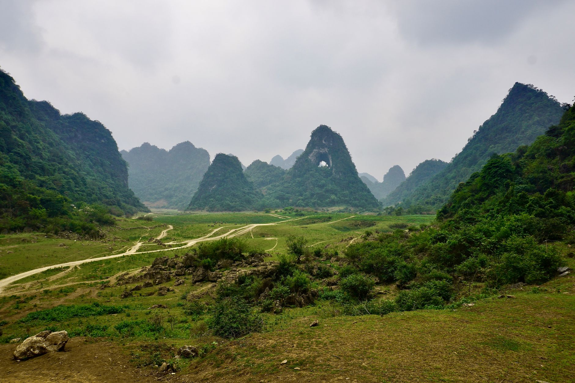 Explore the serene landscape of Angel Eye Mountain with lush green karst formations in Cao Bang, Vietnam.
