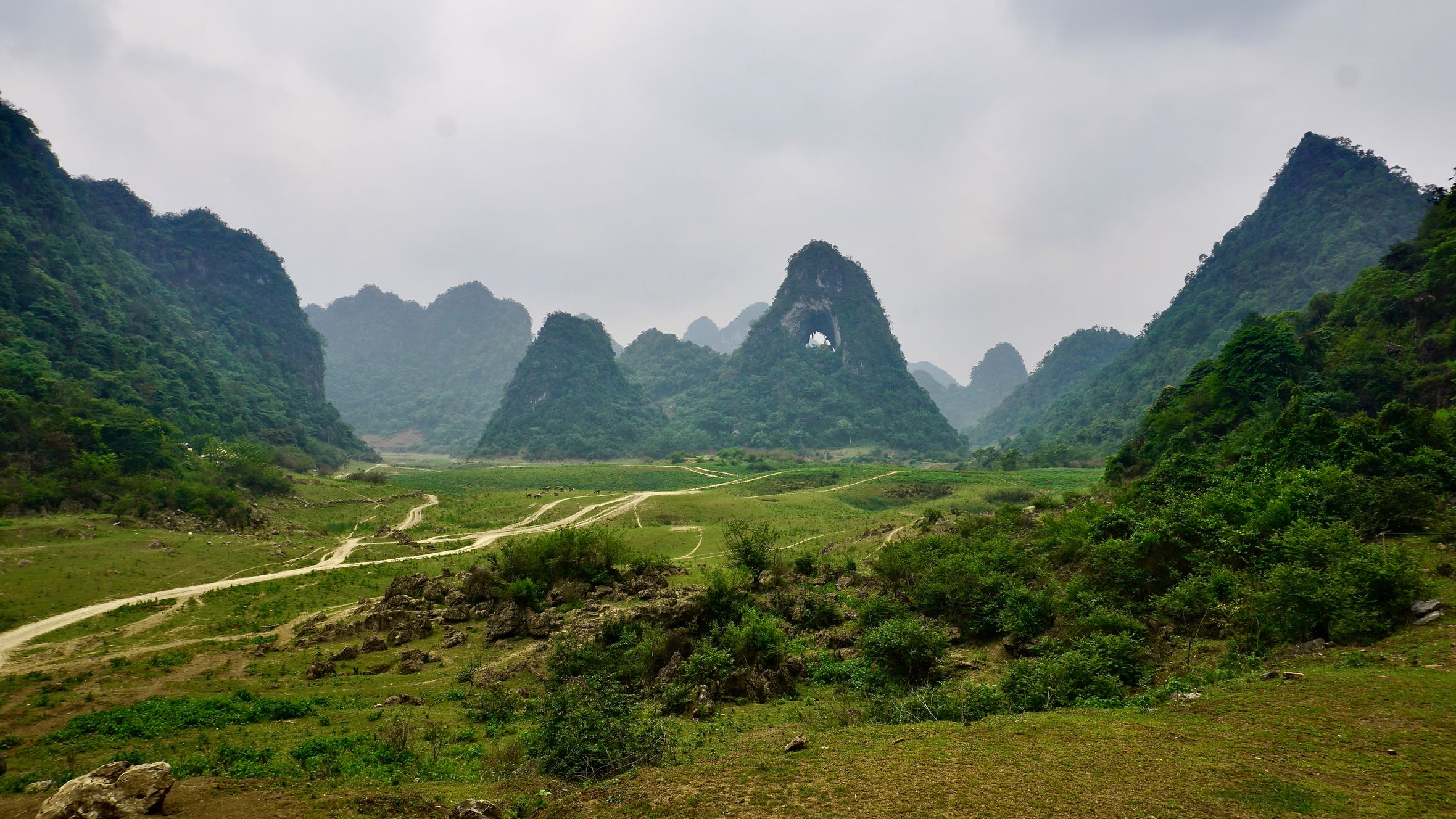 Explore the serene landscape of Angel Eye Mountain with lush green karst formations in Cao Bang, Vietnam.