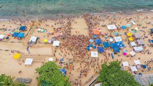 Free People on Beach Watching Beach Volleyball Stock Photo