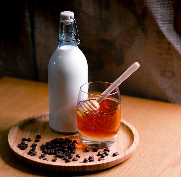 Milk And Honey On Wooden Tray