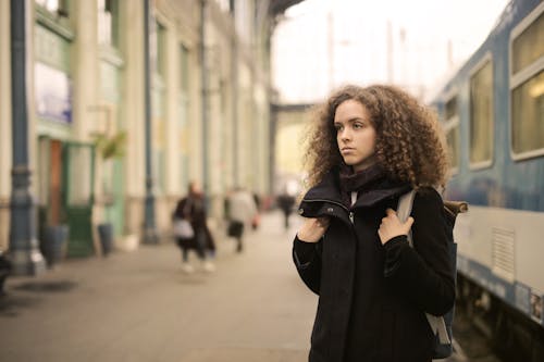 Woman in Black Coat Standing Standing Beside Subway