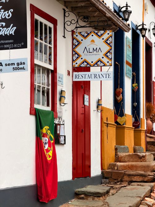 Free Colorful colonial-style restaurant facade with Portuguese flag in Brazil. Ideal for travel themes. Stock Photo
