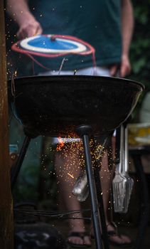 Sizzling outdoor barbecue with sparks flying, capturing a summer grilling scene in London.