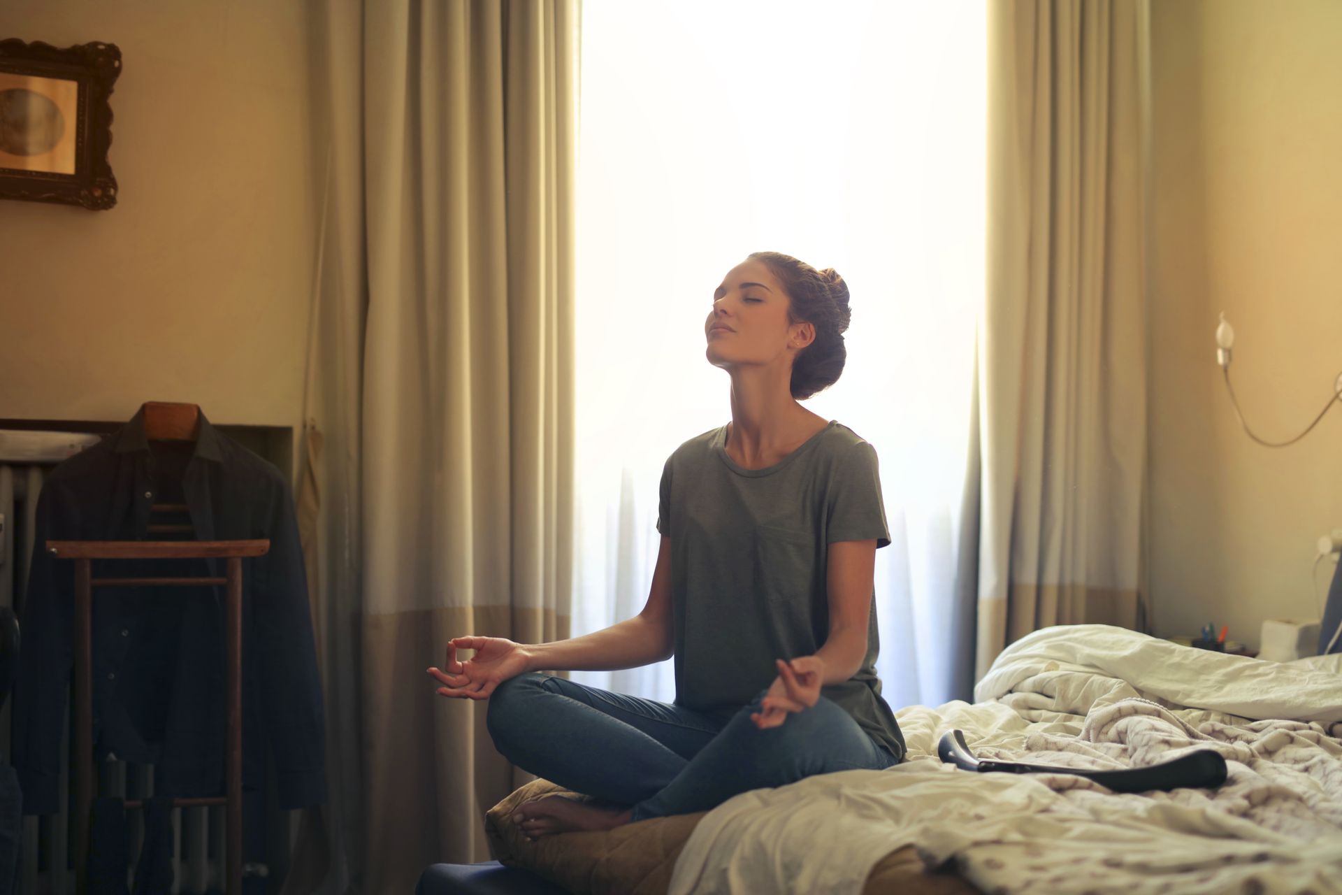 A woman meditating quietly at home