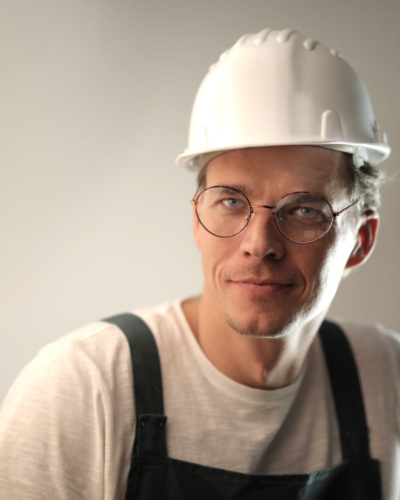 Crawl space technician in a white hard hat