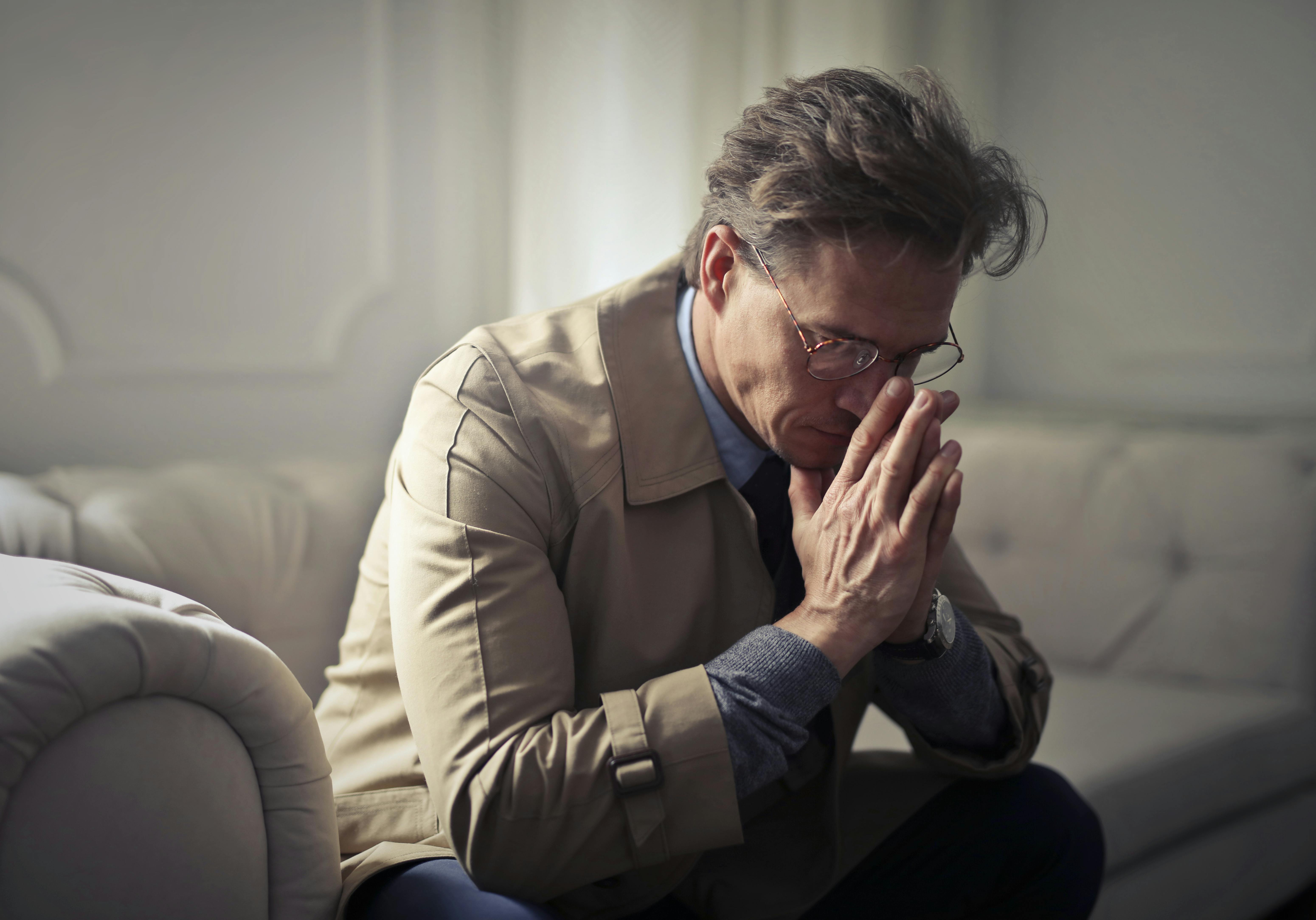 Man thinking about his problems in the living room. | Photo: Pexels