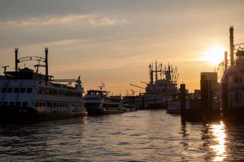 Free Dramatic sunset view of ships in Hamburg harbor, Germany, with a warm and vivid sky. Stock Photo