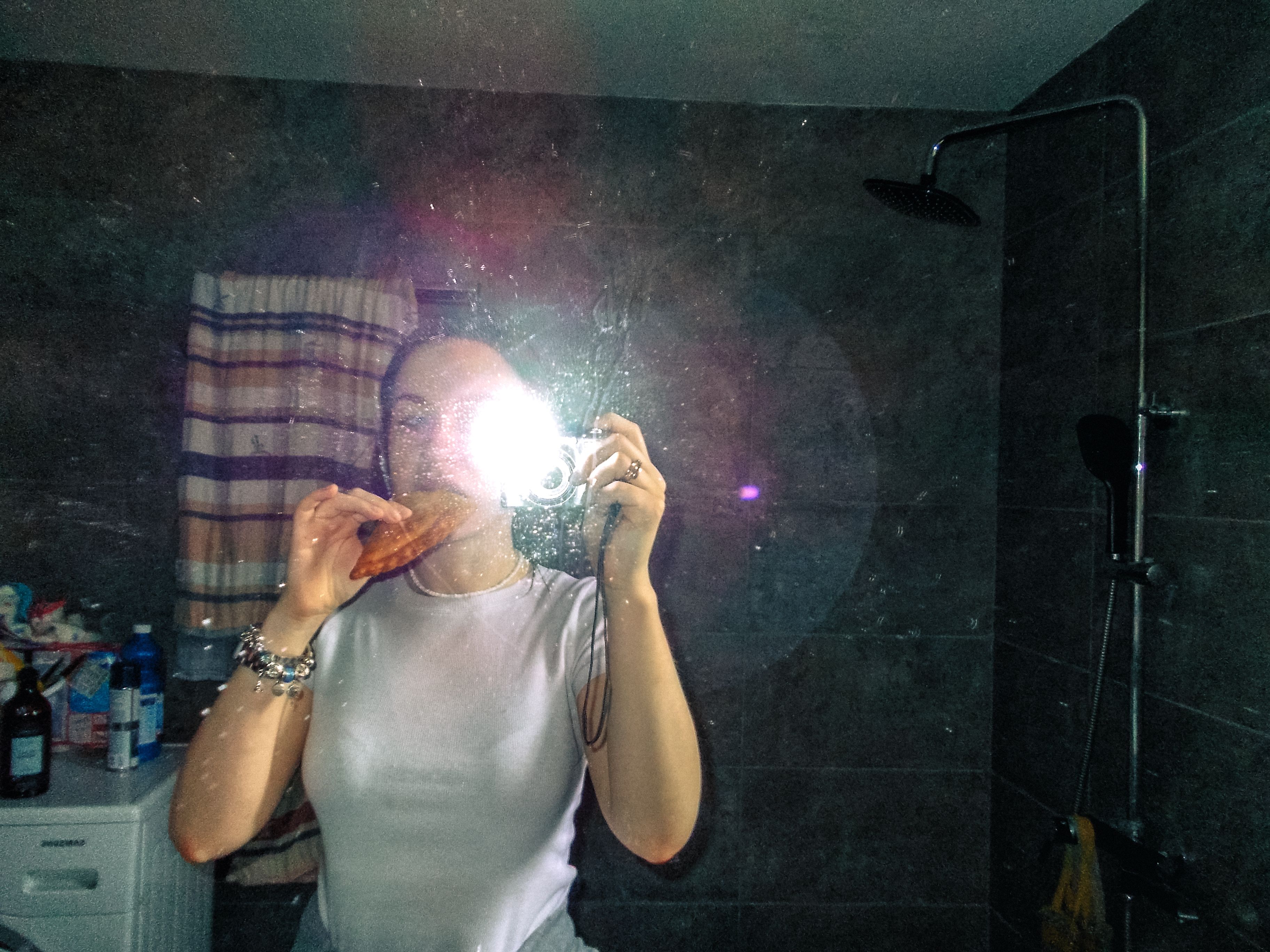 Mirror Selfie with Pastry in Bathroom Setting