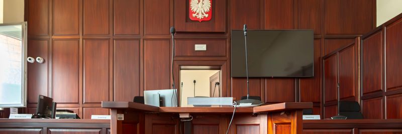Elegant wooden interior of a courtroom in Wrocław, showcasing judicial decor.