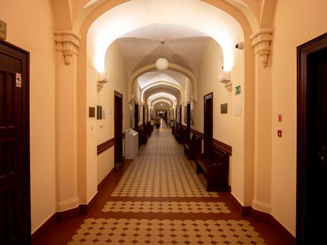 Elegant corridor in a historic Wrocław court with classic architecture.