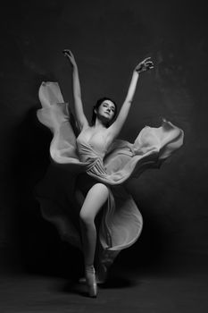 Stunning black and white portrait of an elegant ballet dancer in motion, capturing grace and poise.