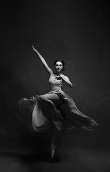 Black and white image of a ballet dancer in motion, showcasing elegance and grace.