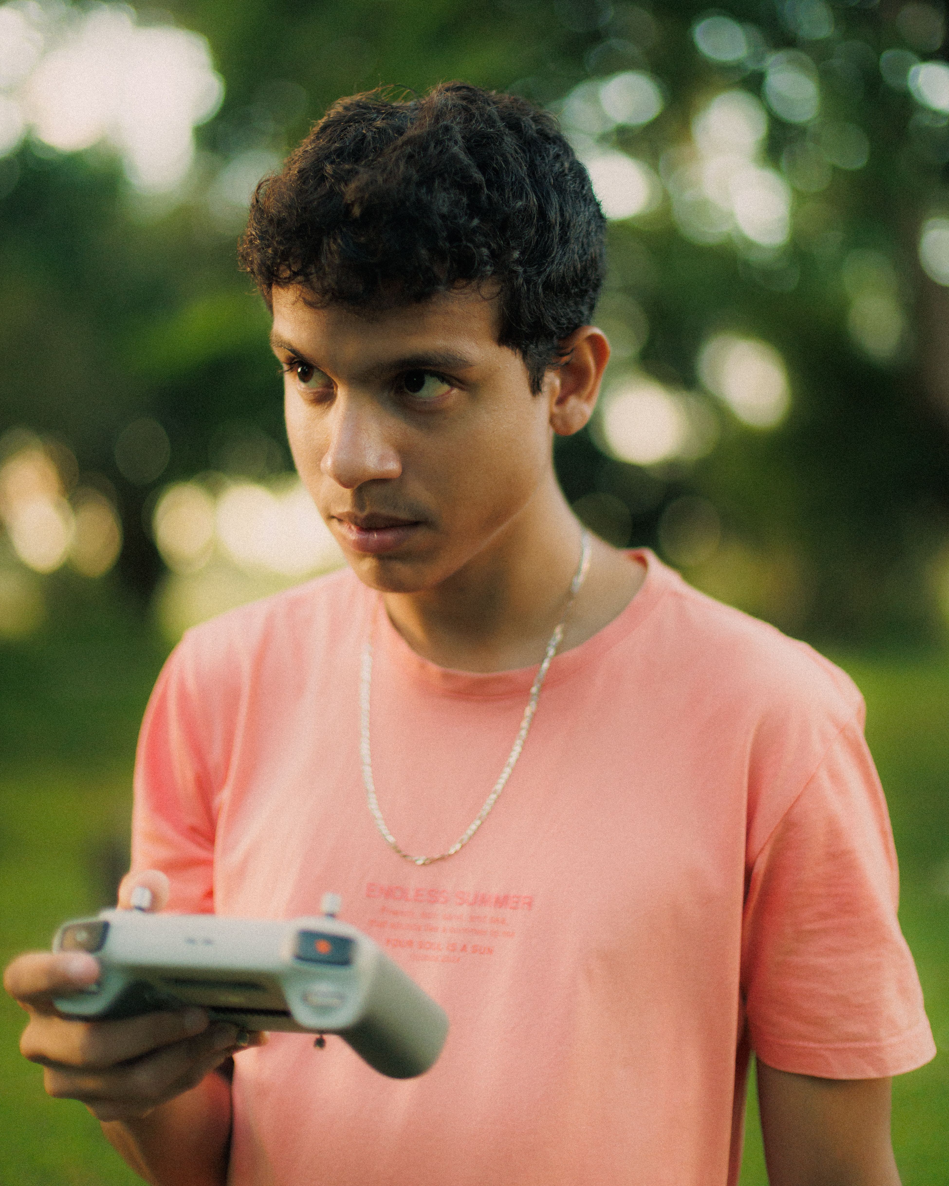 Young man focused on flying a drone outdoors · Free Stock Photo
