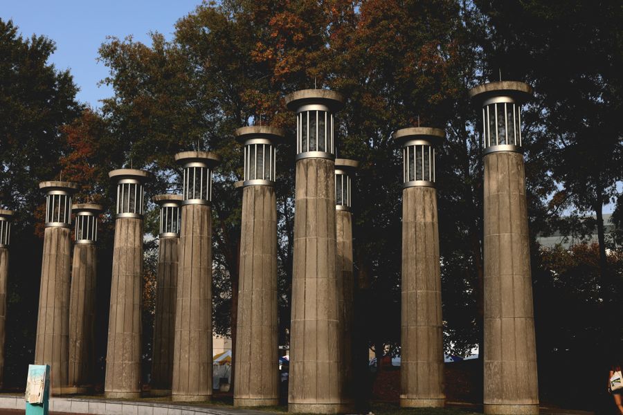 Row of tuned bells mounted on stone columns — photo by Kaitlyn Gilchrist on Pexels