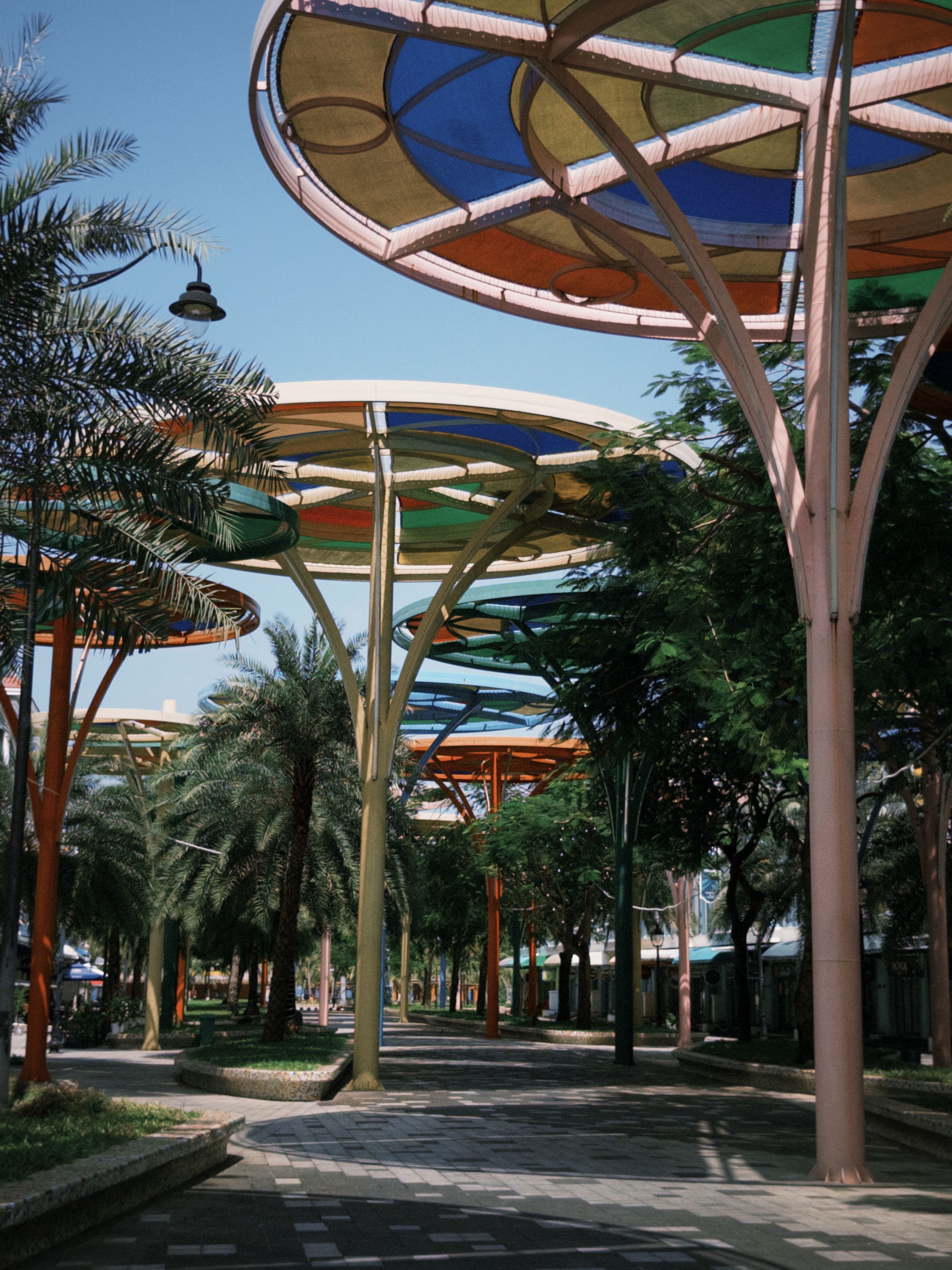 Colorful Canopy Structures Over Walkway · Free Stock Photo