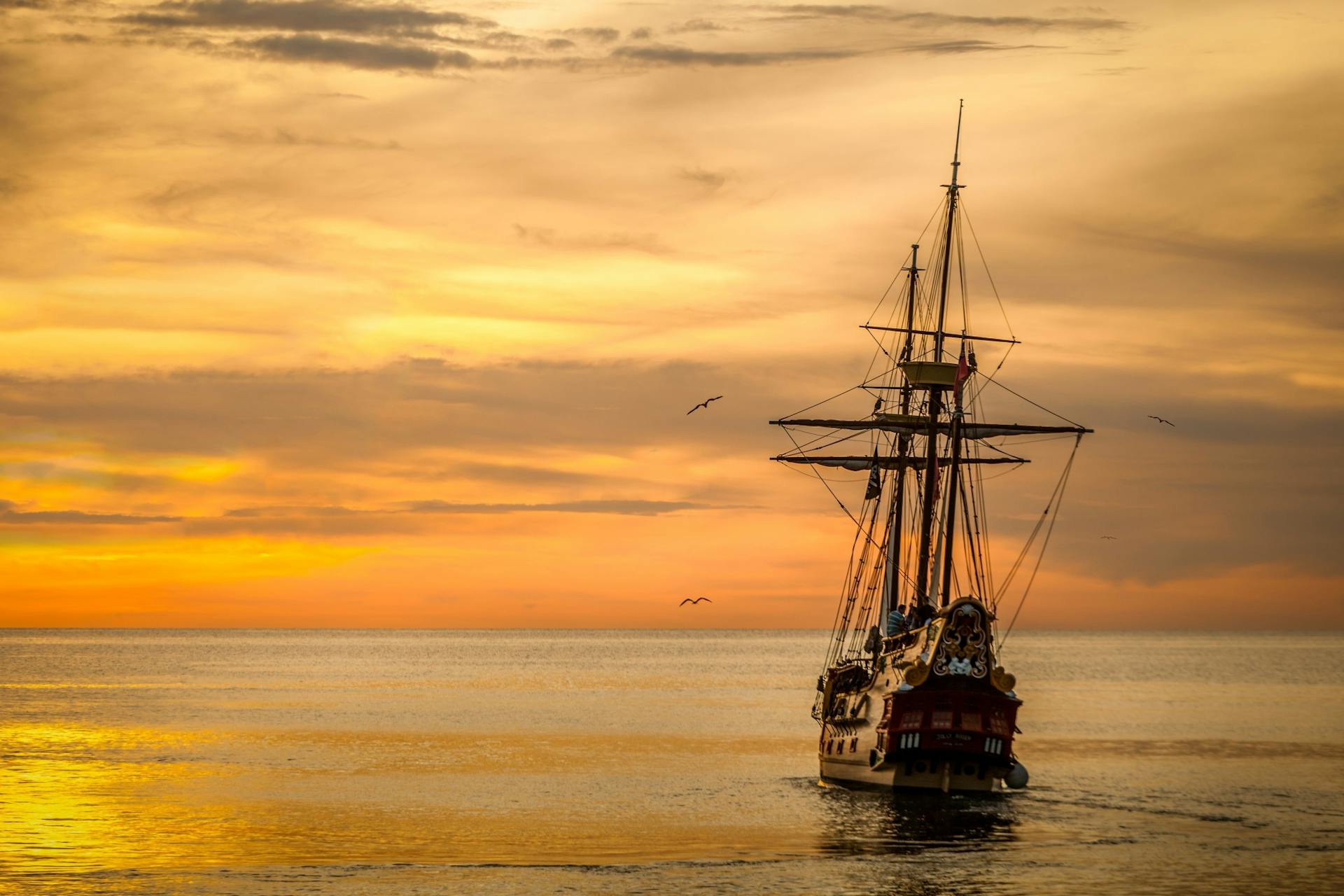 A Pirate Ship Sailing on Sea during Golden Hour